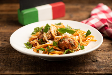 Beef meatballs with bolognese sauce and spaghetti.