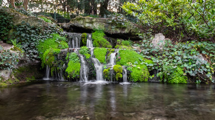 Fototapeta na wymiar Numerous little waterfalls in Pierre Schneiter garden in Reims, France