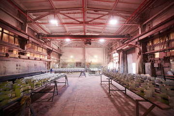 Wide angle background image of industrial workshop at production plant lit by dim red lamps , copy space