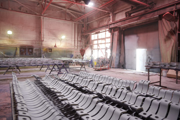 Background image of industrial workshop at production plant lit by dim lamps , copy space