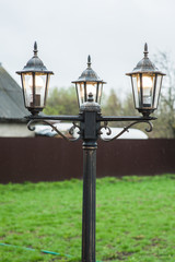Fototapeta na wymiar Vintage garden lantern with three lamps