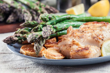 Fried cod fillet with green asparagus
