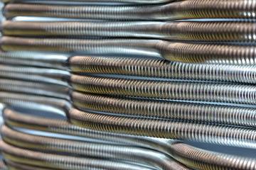 Corrugated stainless metal tubes for water supply. Abstract industrial background.