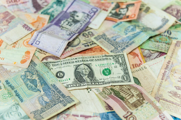 US dollar money bill in front of other international banknotes