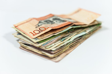 Pile of colorful international banknotes on white background