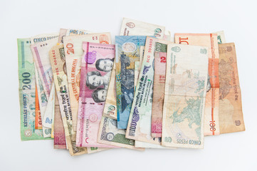 Obraz na płótnie Canvas Different banknotes from all over the world spread on white background