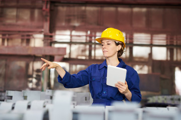 Waist up portrait of female worker supervising production at factory, copy space