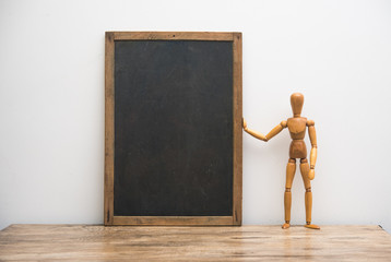 vintage blackboard with wooden frame with wooden doll