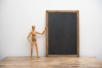 vintage blackboard with wooden frame with wooden doll