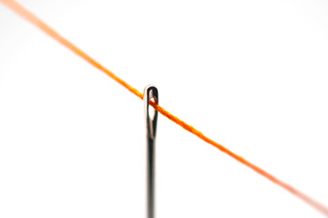 sewing needle with orange thread