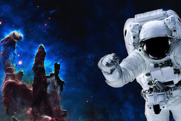 Fototapeta na wymiar Space astronaut near pillars of creation. Space adventure in outer space. Science fiction. Elements of this image were furnished by NASA 