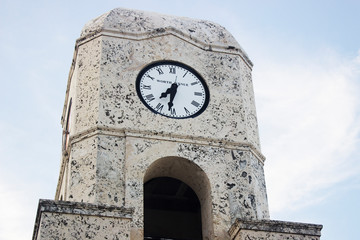 Fototapeta na wymiar Clock tower Worth Avenue in West Palm Beach, Florida close-up with sky background