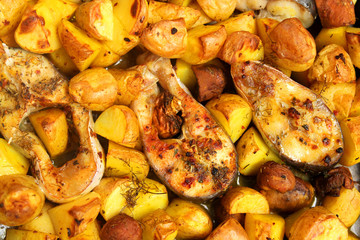 roasted fish and potatoes on the oven