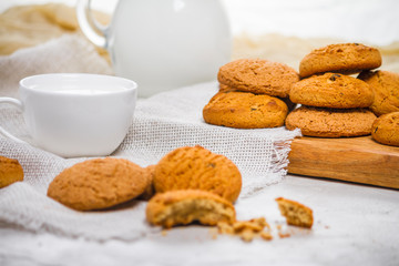Fresh delicious oatmeal cookies and milk for breakfast, selective focus, close-up