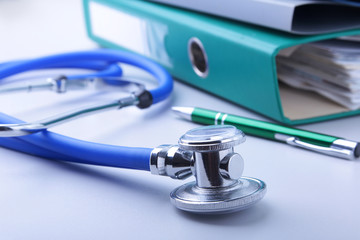 books folder file, stethoscope, red heart and RX prescription isolated on white background.