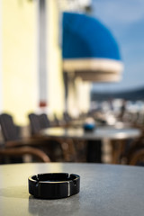 Obraz na płótnie Canvas Closeup of a black ash tray on the table of a coffee shop