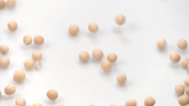 yellow pea on white background falling from top and filling up frame. slow motion 96fps