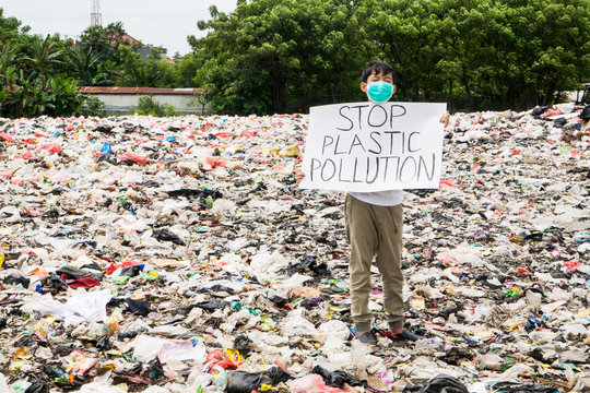 Teenager holding text of stop plastic pollution