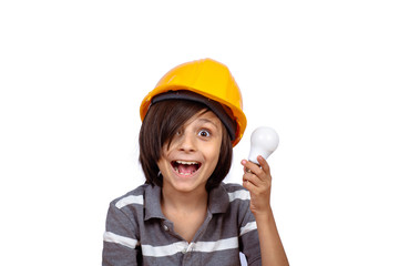 Little boy with construction helmet and holding light bulb.