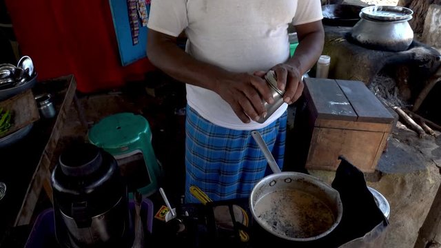 Cook preparing masala tea.