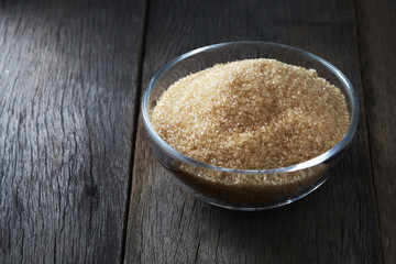 Bowl of brown sugar on the wooden floor