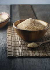 Bowl of brown sugar on the wooden floor