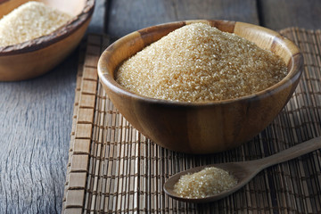 Bowl of brown sugar on the wooden floor