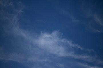Fototapeta premium Fluffy Little Clouds. Blue skies and wispy clouds on a gorgeous summer day.