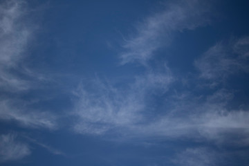 Fluffy Little Clouds. Blue skies and wispy clouds on a gorgeous summer day.