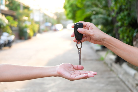 Young businessmen submit car keys to