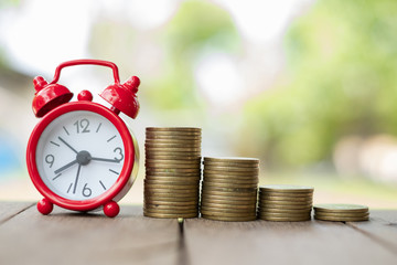 Medal Ladder Starting Business Growth.Financial concepts Creating a silver coin with investment alarm clock, saving money. Most of the time looking for money. Coins stack and alarm clock.