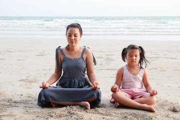 Fototapeta na wymiar Mom is teaching child to do meditation