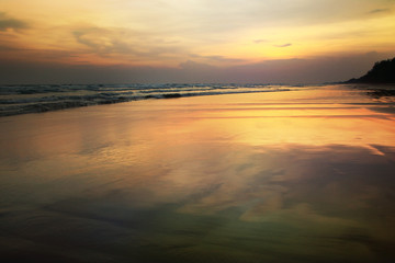 Fototapeta na wymiar Reflections on the beach at sunset background