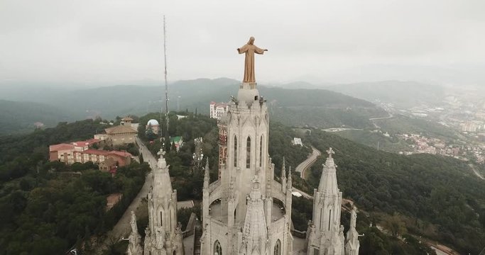 aerial image of tibidabo church in barcelona with mountains in background