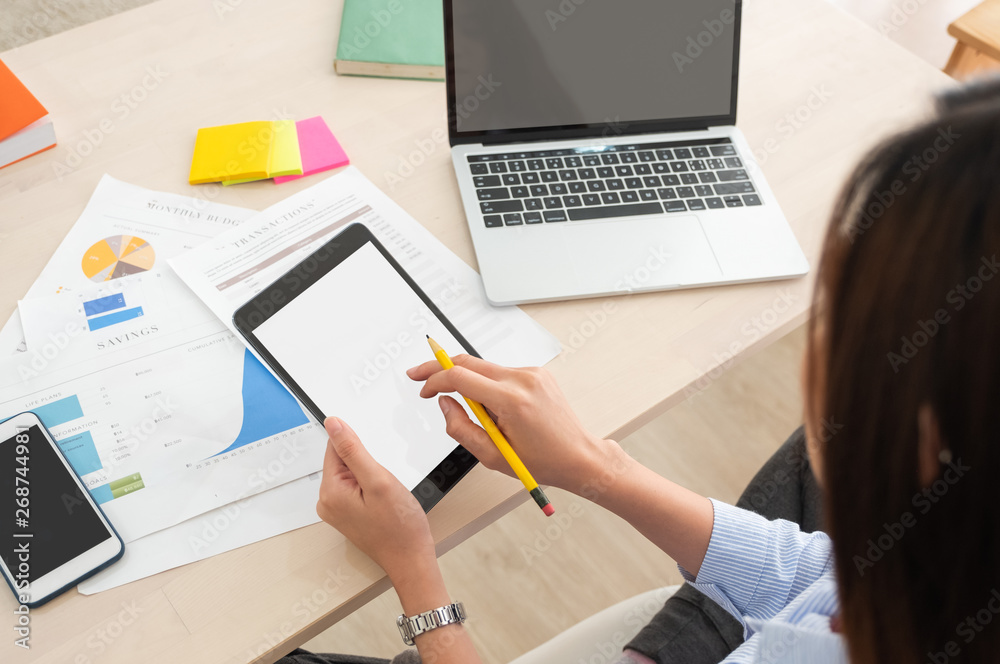 Poster top view woman use tablet and laptop working online on table at home.mock up template device screen.Digital lifestyle concept.clipping path screen.