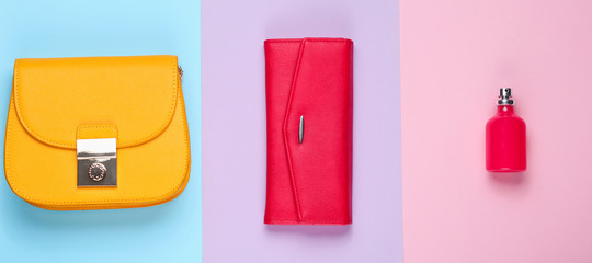 Minimalist fashion. Women's fashion accessories on a pastel background. Leather purse, yellow bag, perfume bottle. Top view