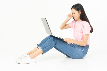Naklejka premium Happy asian teen passenger listening to the music with headphones while holding mobile phone.businesswoman listening to music with headphones while dancing isolated over white background