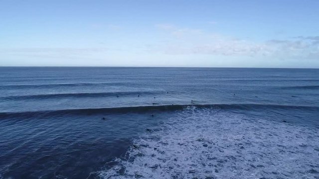 Surfers waiting for waves at Croyde Beach.