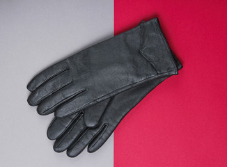 Leather gloves on a red-gray background. Top view
