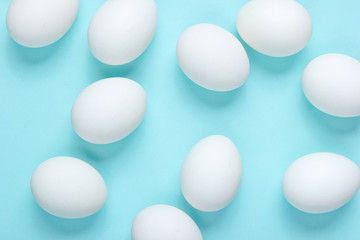 Minimalism food concept. A lot of eggs on a blue background. Top view