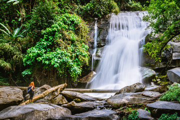 Fototapeta na wymiar Women travel. woman asia travelers travel nature Forests, mountains, waterfalls. Travel Siliphum Waterfall at Chiangmai, in Thailand.