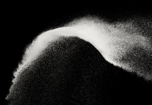 Fine salt or fine sugar splash explosion on black background ,stop motion food object design