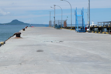 Rusty mooring bollard with ship ropes