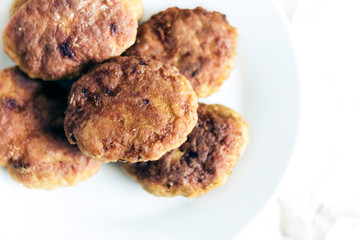 homemade fried minced meat cutlets on white plate, traditional Ukrainian dish .