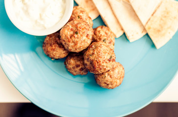 Fried minced meat with sauce and tortillas, traditional Greek lunch on a blue plate in a restaurantю