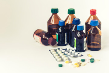 Medicine bottles, pills or capsules blister pack on white background with copy space for text, retro concept closeup.