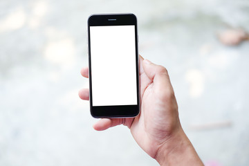 Cropped shot view of man hands holding smart phone with blank copy space screen for your text message or information content, female reading text message on cell telephone during in urban setting.