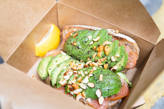 Healthy Food, Avocado Toasts with Sliced Salmon and Almond in the Take away lunch box.