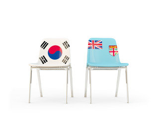 Two chairs with flags of South Korea and fiji isolated on white