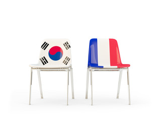 Two chairs with flags of South Korea and france isolated on white